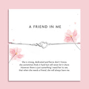 Silver infinity heart bracelet displayed on a friendship poem card with pink floral illustrations, presented as an adjustable bracelet that comes in a soft pink pouch.