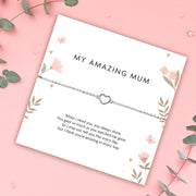Silver bracelet with heart charm on a 'My Amazing Mum' card on a pink background