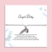 Adjustable grey cord Angel Baby memorial bracelet with silver-tone feather and heart charms, displayed on a blue floral remembrance card with a heartfelt baby loss poem.