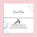 Adjustable grey cord Angel Baby memorial bracelet with silver-tone feather and heart charms, displayed on a blue floral remembrance card with a heartfelt baby loss poem.