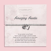 Silver beaded bracelet with heart and flower charms, displayed in a white gift box alongside a card titled "To My Amazing Auntie." The card features a heartfelt message celebrating the love, support, and special bond shared with an aunt.