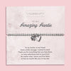 Silver beaded bracelet with heart and flower charms, displayed in a white gift box alongside a card titled 