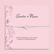 Silver plated Auntie and Niece adjustable bracelet with sparkling cubic zirconia interlocking heart charm, presented on a pink sentiment card and supplied in a soft pink jewellery pouch. Meaningful gift for auntie or niece.