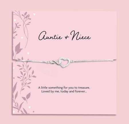 Silver plated Auntie and Niece adjustable bracelet with sparkling cubic zirconia interlocking heart charm, presented on a pink sentiment card and supplied in a soft pink jewellery pouch. Meaningful gift for auntie or niece.
