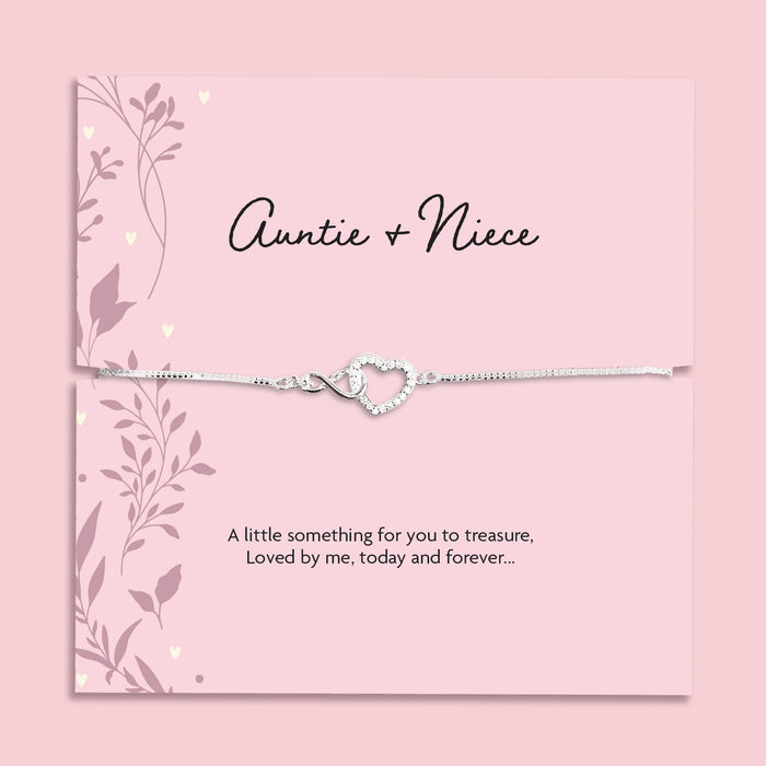Silver plated Auntie and Niece adjustable bracelet with sparkling cubic zirconia interlocking heart charm, presented on a pink sentiment card and supplied in a soft pink jewellery pouch. Meaningful gift for auntie or niece.