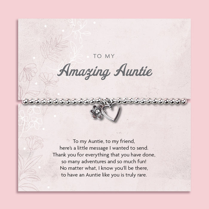 Silver beaded bracelet with heart and flower charms, displayed in a white gift box alongside a card titled "To My Amazing Auntie." The card features a heartfelt message celebrating the love, support, and special bond shared with an aunt.