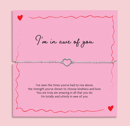Silver chain bracelet with open heart charm displayed on a pink “I’m In Awe Of You” poem card with red heart illustrations, meaningful gift for her.