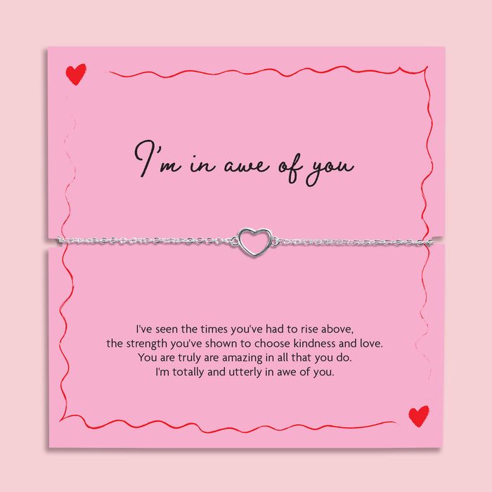 Silver chain bracelet with open heart charm displayed on a pink “I’m In Awe Of You” poem card with red heart illustrations, meaningful gift for her.