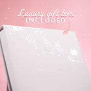 A pale pink background with text that reads 'luxury gift box included' and an arrow pointing to the box. The box is white with floral silver details.