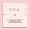 Silver heart charm bracelet displayed on a blush pink “Best Day Ever” poem card with delicate star illustrations. A sentimental silver bracelet gift for graduation, weddings, or milestone celebrations.