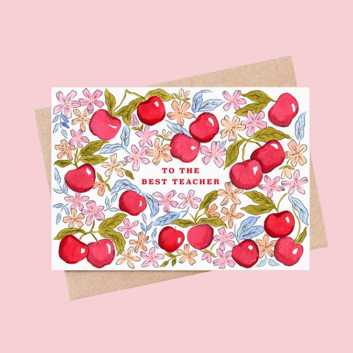 Illustrated "To The Best Teacher" greetings card featuring red cherries, pink flowers and green foliage on a white background, supplied with a recycled kraft envelope.