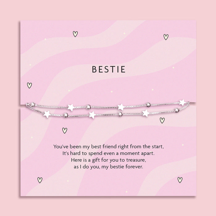 Silver-plated star bracelet on a pink wavy poem card with a meaningful sentiment for a friend. Making a perfect gift for a best friend.