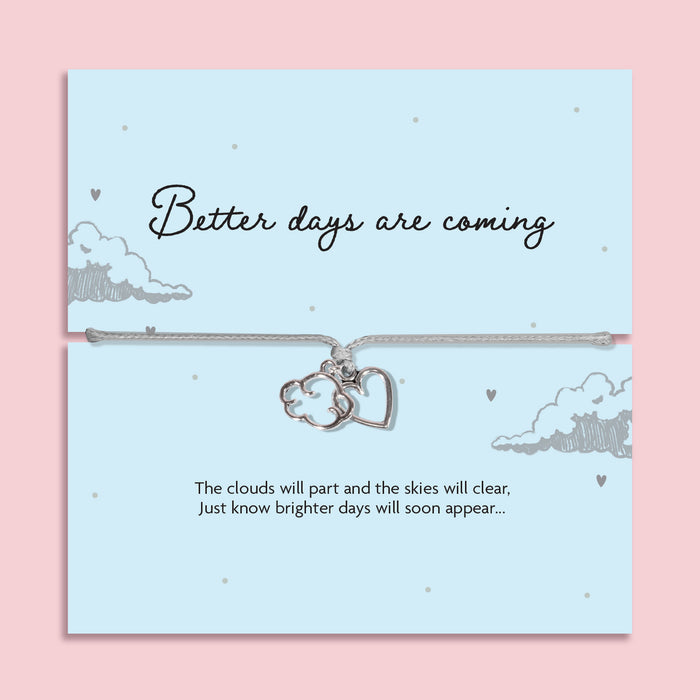 Grey adjustable cord bracelet featuring silver plated cloud and heart charms on a keepsake card reading "Better Days Are Coming." A thoughtful encouragement, thinking of you, sympathy or cheer up gift, presented in a luxury white butterfly envelope.