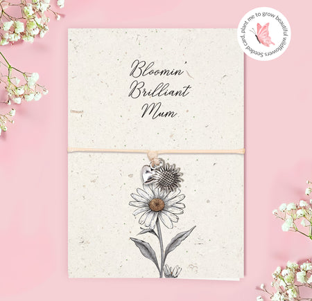 Adjustable string bracelet with silver heart and sunflower charms presented on a plantable seeded greeting card reading “Bloomin’ Brilliant Mum” with daisy illustration.