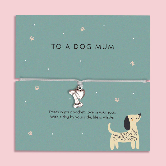 Silver bone and heart charm bracelet for dog mums, featuring a grey cord and a heartfelt sentiment card about the special bond between a dog and its owner.