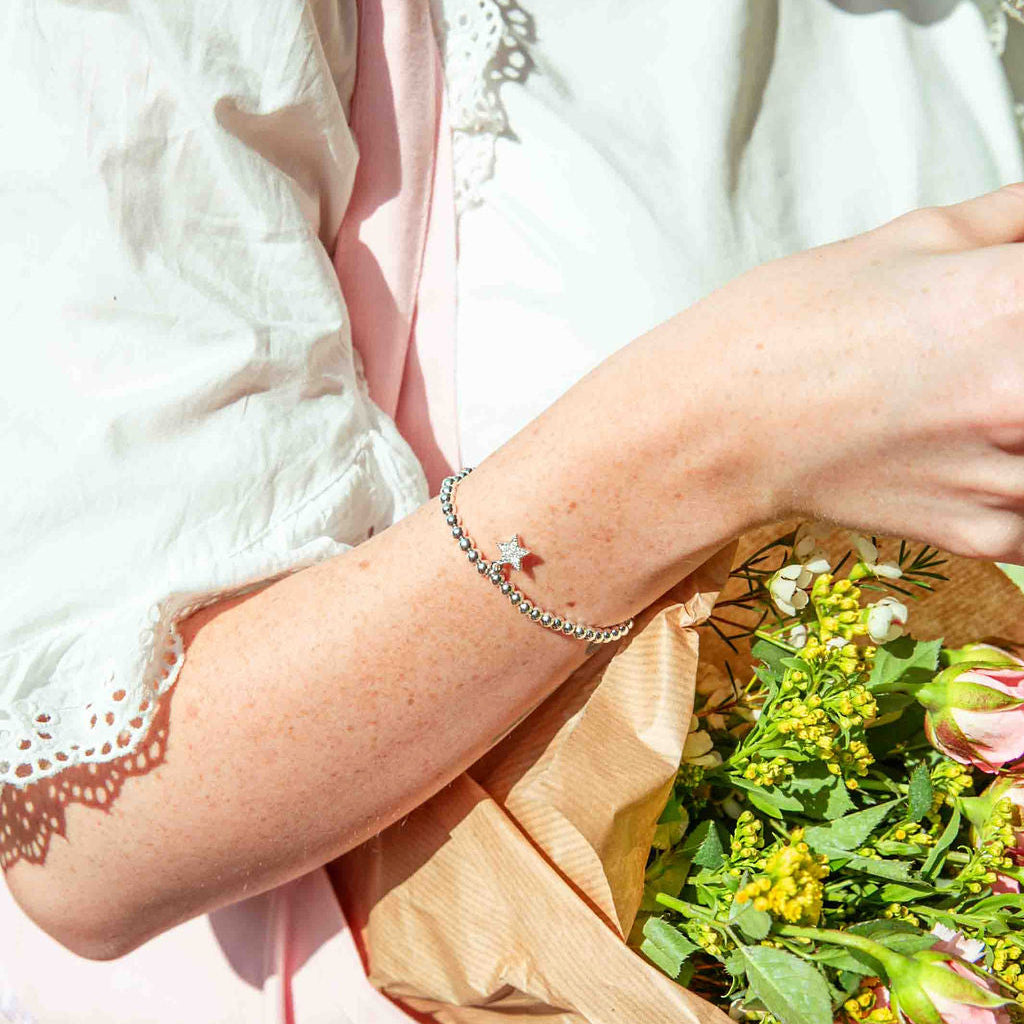 Person holding a bouquet of flowers with a blurred background