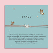 Grey cord bracelet with a silver butterfly charm, displayed on a teal card with butterflies and the word 'Brave'. The card features an inspirational message about strength, resilience, and courage. An empowering gift from Letterbox Love.