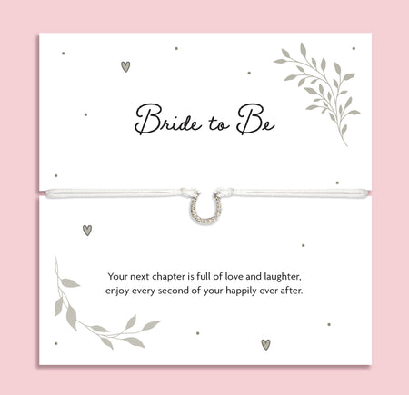 Bride to Be sentiment card featuring an adjustable white cord bracelet with a sparkling horseshoe charm, meaningful bridal shower gift and wedding keepsake for the future bride.