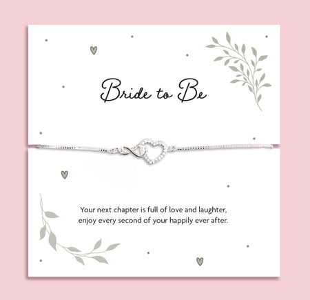 Silver zirconia heart and infinity charm bracelet displayed on a white card with the words 