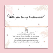 Bridesmaid proposal bracelet with silver bow charm on adjustable cord, presented on sentimental poem card. Perfect jewellery gift for proposal gift boxes and bridal party keepsakes