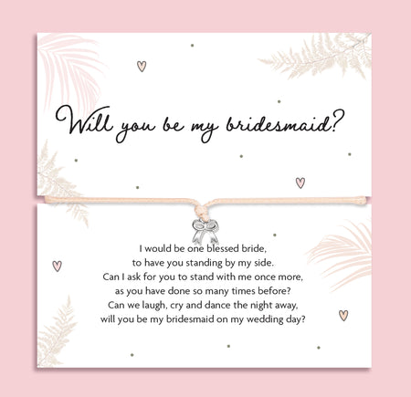 Bridesmaid proposal bracelet with silver bow charm on adjustable cord, presented on sentimental poem card. Perfect jewellery gift for proposal gift boxes and bridal party keepsakes