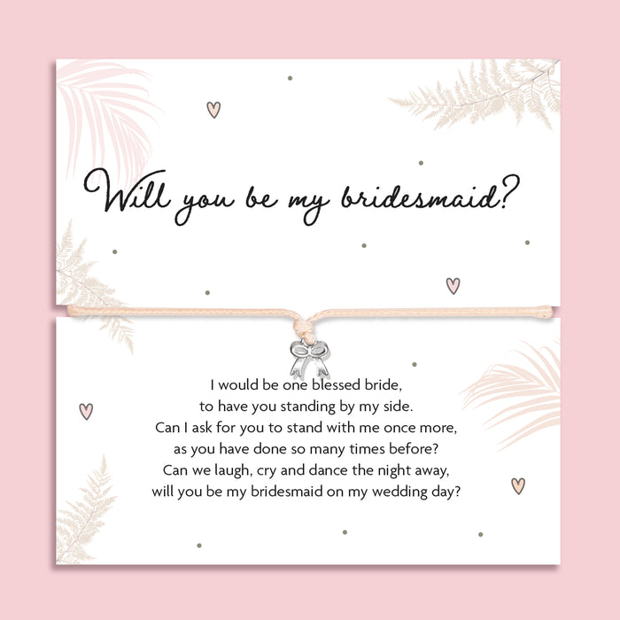 Bridesmaid proposal bracelet with silver bow charm on adjustable cord, presented on sentimental poem card. Perfect jewellery gift for proposal gift boxes and bridal party keepsakes
