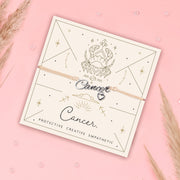 Bracelet with 'Cancer' zodiac sign charm on a card with astrological design on a pink background. Cute star sign bracelet with free gift wrapping