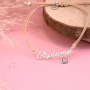 Meaningful bracelet with 'Capricorn' pendant on a pink background and a cute heart charm. Affordable zodiac jewellery for her.