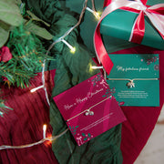 A christmas table with green and ruby colour drapes and wrapped presents. Central are two meaningful gifts from Letterbox Love for Xmas. One reads 'have a happy Christmas' and the other 'my fabulous friend.' Making a beautiful gift for a friend at xmas