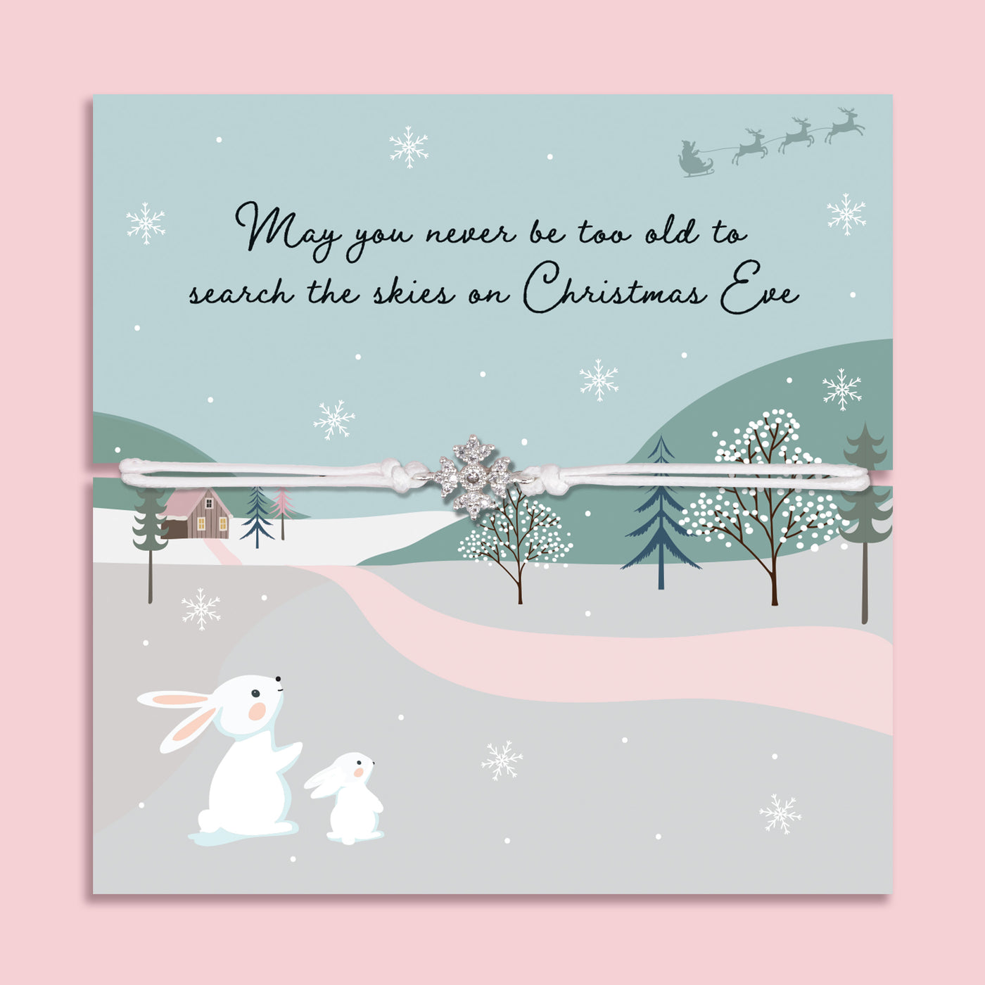 Christmas Eve bracelet featuring a sparkling cubic zirconia snowflake charm on an adjustable cord, presented on a festive card with snowy hills, winter trees, rabbits, and the message “May you never be too old to search the skies on Christmas Eve.” Includes a soft white pouch for gifting and safekeeping. A thoughtful Christmas Eve surprise, festive jewellery gift, or stocking filler for loved ones of all ages, symbolising the magic and sparkle of the holiday season.