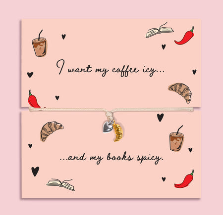 Adjustable book lover bracelet with silver-plated heart charm and gold-tone croissant charm on a peach “I want my coffee icy… and my books spicy” card.