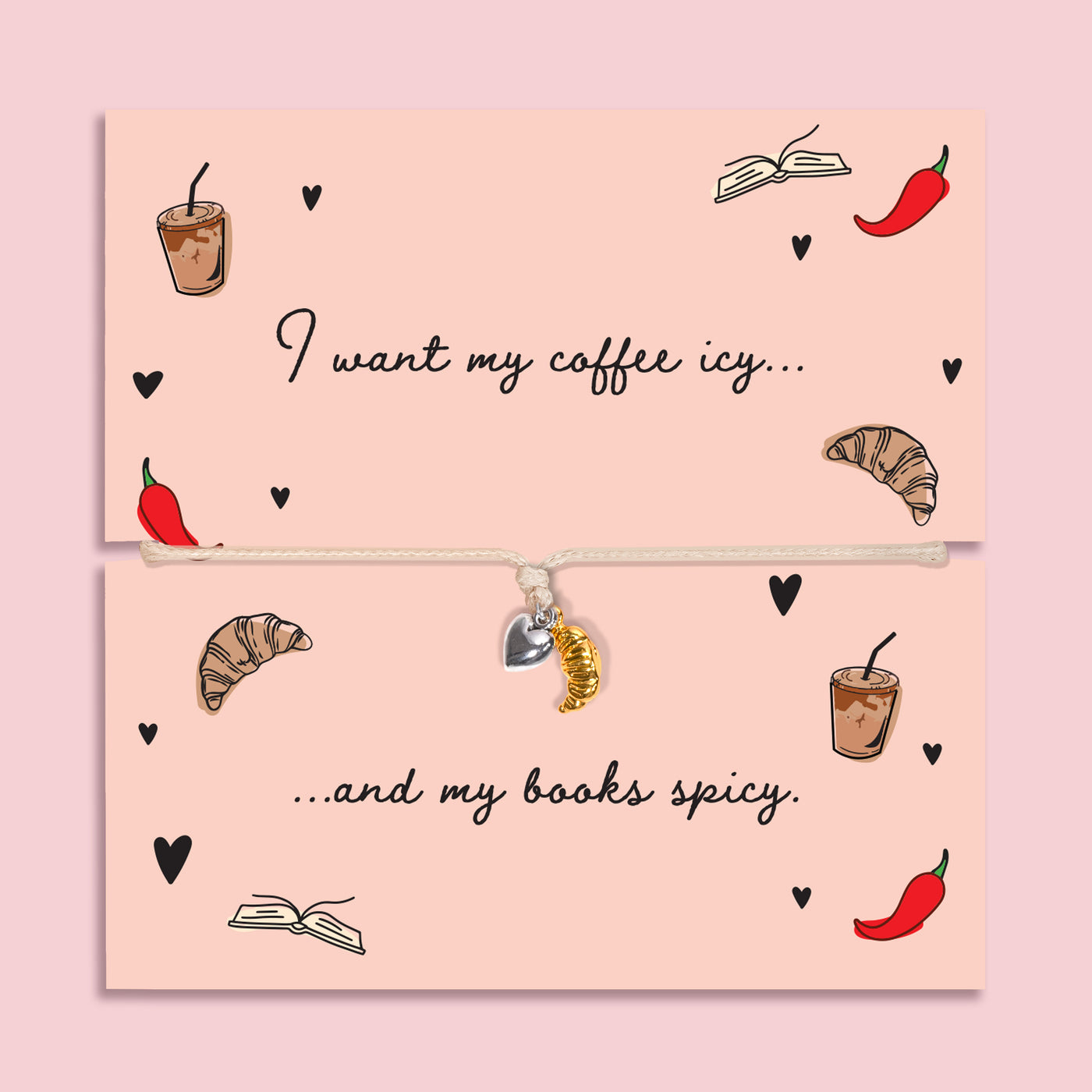 Adjustable book lover bracelet with silver-plated heart charm and gold-tone croissant charm on a peach “I want my coffee icy… and my books spicy” card.