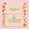 Cosy Season autumn bracelet featuring a silver maple leaf charm on an adjustable cord, presented on a seasonal card with pumpkins, leaves, and cosy illustrations. Perfect autumn jewellery gift, fall accessory, or thoughtful present for birthdays, Thanksgiving, or seasonal celebrations. Our bracelet is ready to gift and captures the warmth of autumn, making it an ideal keepsake for lovers of fall fashion and meaningful jewellery.