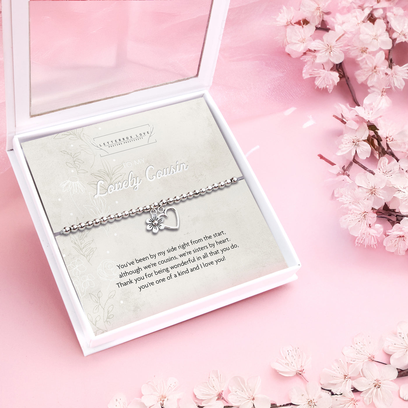 Silver beaded bracelet with heart and flower charms, presented in a white gift box with a sentimental card titled 