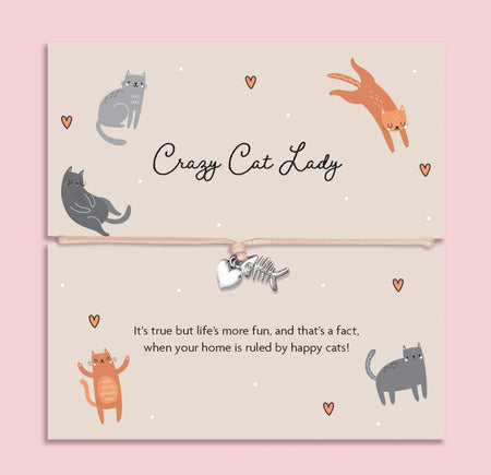 Cute illustrated card with playful cats and the phrase “Crazy Cat Lady,” featuring a beige string bracelet with silver fishbone and heart charms, a fun, light-hearted gift for cat lovers and proud cat mums.