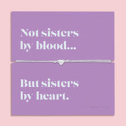 Mounted on a vibrant card with the heartfelt message: "Not sisters by blood… but sisters by heart," this bracelet is the perfect keepsake to show your appreciation for someone who means the world to you.
