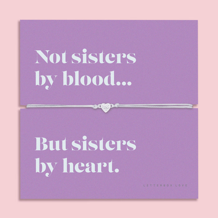 Mounted on a vibrant card with the heartfelt message: "Not sisters by blood… but sisters by heart," this bracelet is the perfect keepsake to show your appreciation for someone who means the world to you.