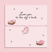 Pink adjustable cord bracelet with cute pig charm displayed on Love You to the Sty and Back message card, fun novelty love gift with pig illustrations.