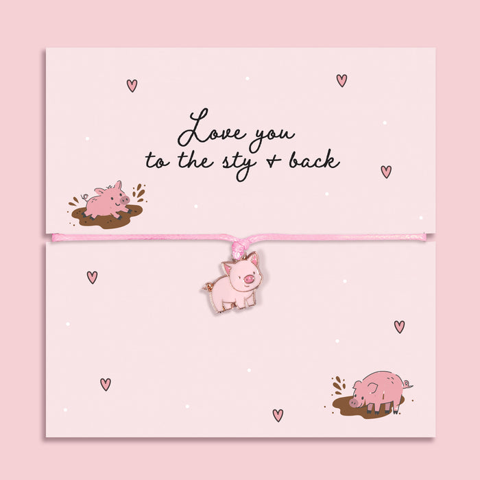 Pink adjustable cord bracelet with cute pig charm displayed on Love You to the Sty and Back message card, fun novelty love gift with pig illustrations.