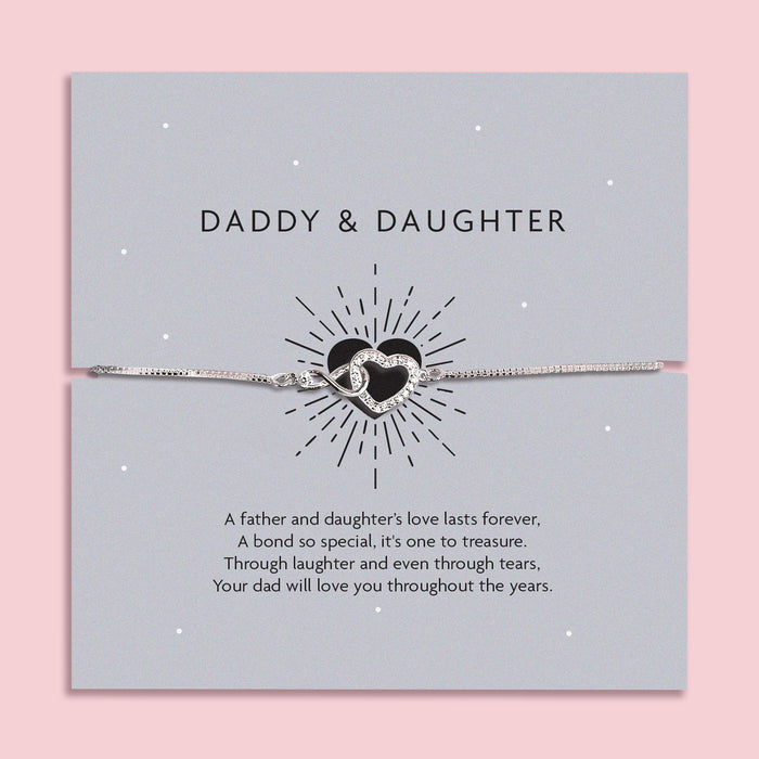 Silver infinity heart bracelet on a grey card with the words "Daddy & Daughter," featuring a heartfelt poem celebrating a father's love for his daughter.