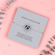 Silver infinity heart bracelet on a grey card with the words "Daddy & Daughter," featuring a heartfelt poem celebrating a father's love for his daughter.
