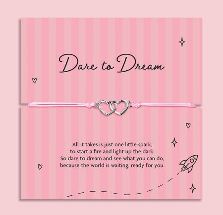 Dare to Dream encouragement bracelet with interlinked heart charms on pink adjustable cord, displayed on inspirational keepsake card with motivational poem, thoughtful gift for someone chasing their dreams.