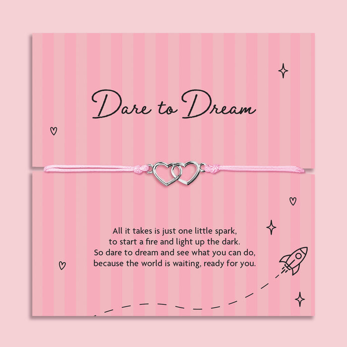 Dare to Dream encouragement bracelet with interlinked heart charms on pink adjustable cord, displayed on inspirational keepsake card with motivational poem, thoughtful gift for someone chasing their dreams.