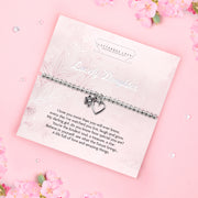 A silver beaded bracelet with a heart and flower charm displayed on a card reading "To my Beautiful Daughter" from Letterbox Love, set against a soft pink background with delicate flowers. The card features a heartfelt message, making it a thoughtful gift for a daughter.