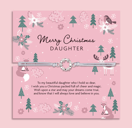 Merry Christmas Daughter bracelet featuring a silver wreath charm on an adjustable cord, presented on a festive pink card with woodland animals, reindeer, fox, birds, and Christmas trees. Perfect Christmas jewellery gift from mum or dad, this sentimental bracelet is ready to gift and makes a meaningful present for daughters of all ages. A thoughtful holiday keepsake, ideal as a Christmas morning surprise, stocking filler, or festive jewellery gift.