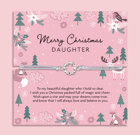 Merry Christmas Daughter bracelet featuring a silver wreath charm on an adjustable cord, presented on a festive pink card with woodland animals, reindeer, fox, birds, and Christmas trees. Perfect Christmas jewellery gift from mum or dad, this sentimental bracelet is ready to gift and makes a meaningful present for daughters of all ages. A thoughtful holiday keepsake, ideal as a Christmas morning surprise, stocking filler, or festive jewellery gift.