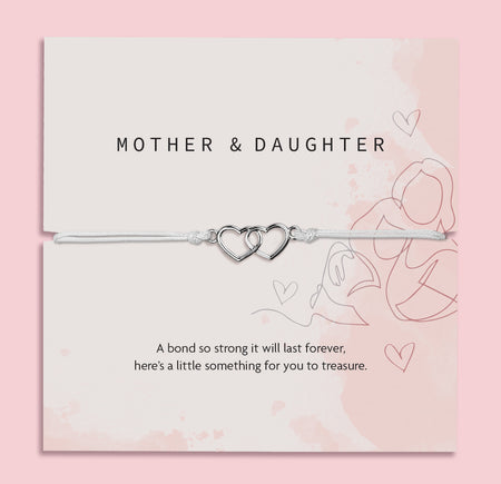 Silver bracelet with interlocking hearts on a 'Letterbox Love' card with text on a pink background. A meaningful gift under £10 for a mother and daughter