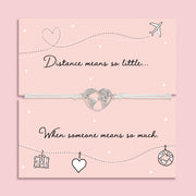 Long distance friendship bracelet with world heart charm on card reading “Distance means so little when someone means so much”, adjustable cord bracelet gift for loved ones far away