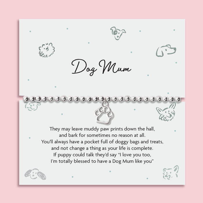 A pink background with an illustrated dog poem card with thoughtful poem about being a Dog Mum. The bracelet around the card is a silver-plated beaded bracelet with a cute dog paw charm.