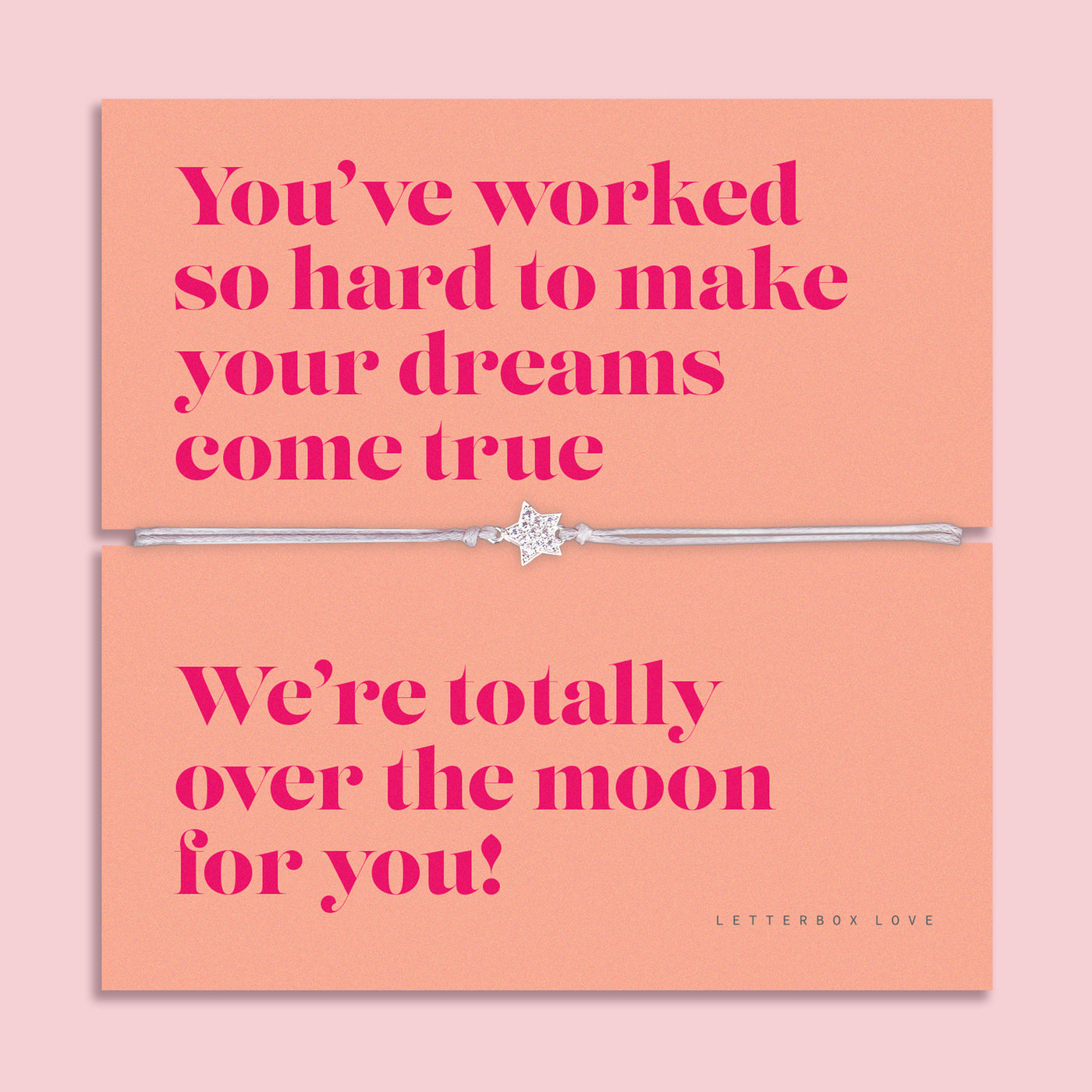 Dreams Come True bracelet with a star charm on a silver band, displayed on a vibrant coral message card with bold pink lettering, celebrating achievement and success